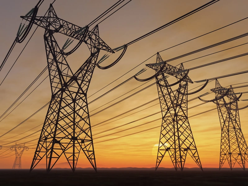 The silhouette of the high voltage power lines during sunset.