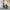 Child in school uniform sitting next to woman in train station platform chatting